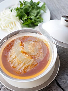 Chinese Shark`s Fin Soup with crab meat, sea cucumber and conch in brown soup.