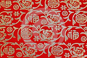 Chinese shiny ornament on red fabric