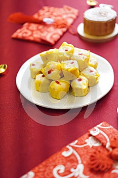 Chinese snacks rice or wheat dough enclosing minced meat and steamed on red color textile Chinese New Year