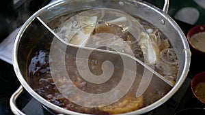 Chinese spicy hot pot cuisine while cooking meatball, fishball and wanton in hot boil chinese style soupbase