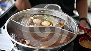 Chinese spicy hot pot cuisine while cooking meatball, fishball and wanton in hot boil chinese style soupbase