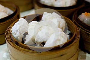 Chinese steamed barbecue pork bun on bamboo steamer.