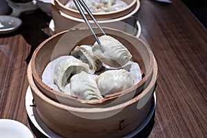 Chinese steamed dumplings in bamboo steamer, close up