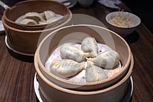 Chinese steamed dumplings in bamboo steamer, close up