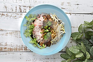 Chinese steamed rice noodle with stewed pork , tofu, dried shrimps, and bean sprout, put in ceramic dish, Thailand food.