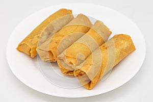 Chinese Style Crispy Vegetarian Spring Rolls on a White Plate