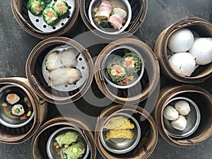 chinese style steamed dim sum dishes in bamboo baskets