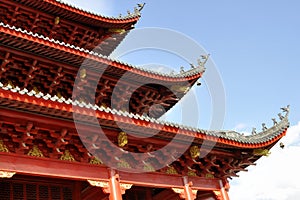 Chinese style temple roof against blue sky background