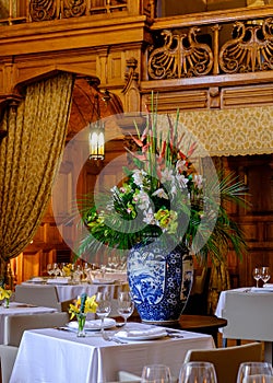 Chinese style vase with flowers with a restaurant interior on th