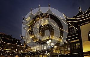 Chinese-style wooden buildings in Shanghai Yu Garden illuminated by lights