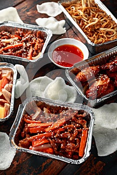 Chinese takeaway food. Crispy shredded beef, sweet and sour chicken wings, egg noodles with bean sprouts, pineapple