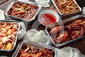Chinese takeaway food. Crispy shredded beef, sweet and sour chicken wings, egg noodles with bean sprouts, pineapple