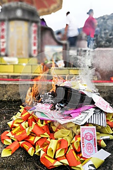 Chinese taoism tradition burn paper money and gold to ancestors