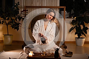 Chinese Tea Ceremony experience. Woman participating in a traditional tea ceremony at home