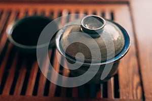 Chinese tea cup or Gaiwan on wooden tea table, selective focus