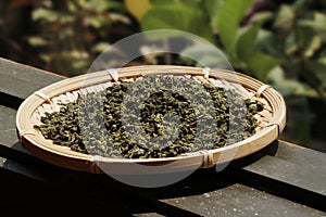 Chinese tea leaves on a basket plate