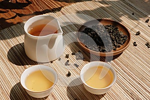 Chinese tea leaves and tea drinks on rustic wooden table