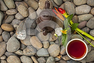 Chinese tea set and flowers Put on granite piles