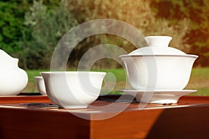 Chinese tea set on a wooden desk outdoors