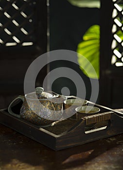 Chinese teapot and glasses on color back