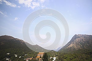 Chinese temple on a background of mountains and sky. Beautiful landscape.