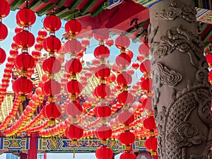Chinese Temple detailed ornate column and Red Lanterns against a blue sky