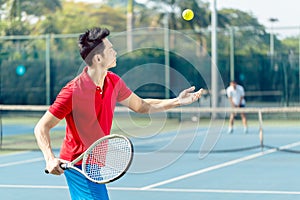 Chinese tennis player ready to hit the ball while serving in a tennis match