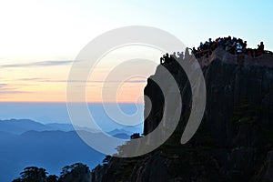 Chinese tourist crowd watching sunrise at Huangshan Yellow mountain in Anhui province, China, Asian landscape