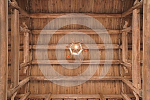 Chinese traditional ancient building with wooden beams and paper lanterns on the roof