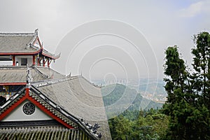 Chinese traditional building on mountaintop against sunny afternoon sky
