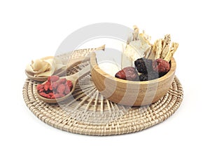 Chinese traditional nourishing healthy food - Chinese herbal medicine - ginseng, gojiberry isolated on white background