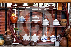 Chinese traditional tea sets, teapots and cups on mahogany shelf