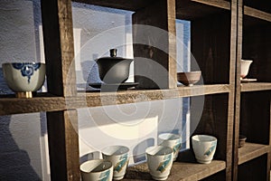 Chinese traditional teaware on the shelves in the tea house