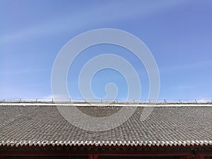 Chinese traditional tiled roof and blue sky with top copy-space; taken in Shenyang, Liaoning province, China.
