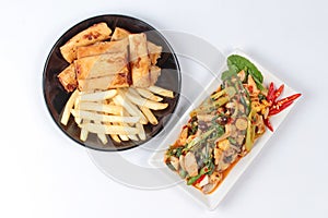 Chinese Vegetable festival food as fried basil with mixed vegetable served deep fried spring roll and French fries .