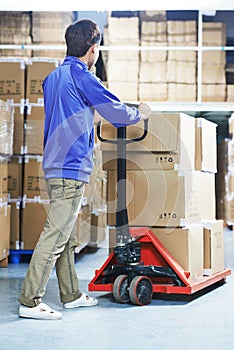 Chinese warehouse worker with forklift stacker