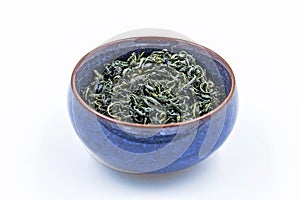 Chinese Wild Green tea. Ye Sheng Lu Cha in a blue ceramic bowl