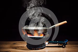 Chinese wok pan on fire gas burner