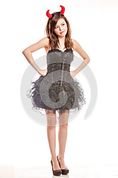 Chinese woman in black dress and devil horns standing with hands photo