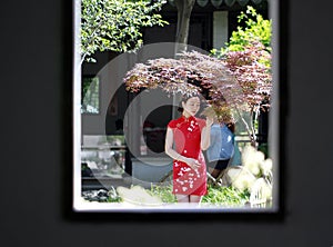 Chinese woman in cheongsam in Mudu ancient town, the picture looks like picture in picture