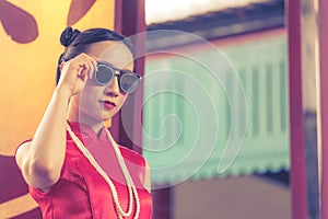 Chinese woman Cheongsam with sunglasses for chinese Ganster concept photo