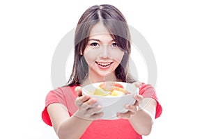 Chinese woman holding bowl of fruit