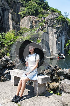 Chinese woman holding an umbrella to shade herself shaoxing china