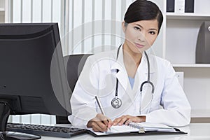 Chinese Woman Hospital Doctor Writing In Office