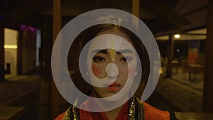 A Chinese woman looked very sad while her face looks like a clown's during the festival
