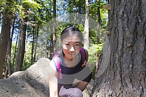 Chinese woman out hiking in a forest