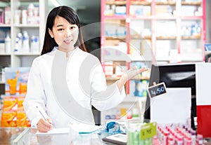Chinese woman pharmacist working in pharmacy