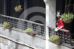 A Chinese woman in red dress in Feng Jing ancient town