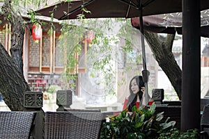 A Chinese woman in red dress in Feng Jing ancient town