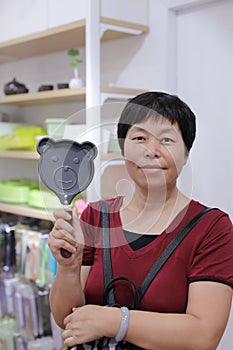 Chinese woman in red shirt hold little bear pan saucepan